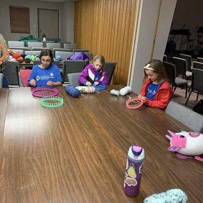 AHG making baby hats to donate to pregnancy center